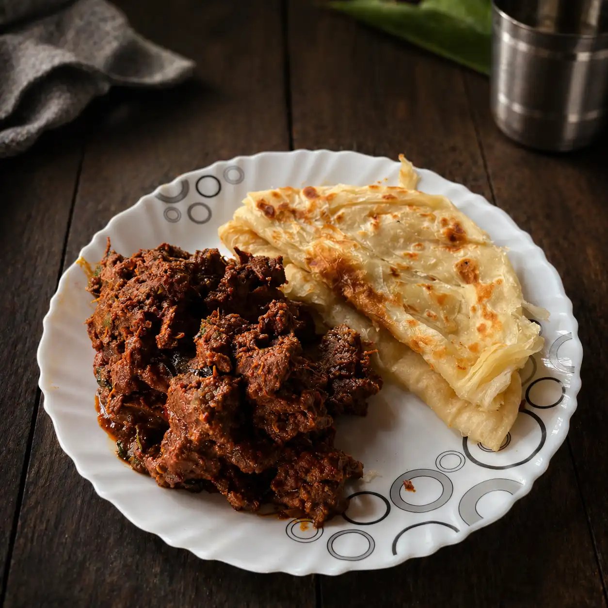 Porotta and beef curry served at KollyaBeef restaurant